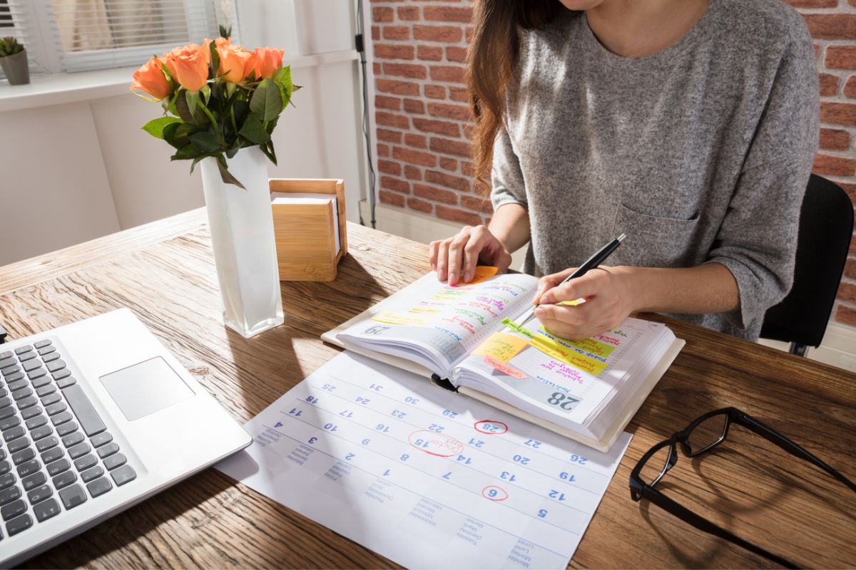 Women writing in the best ADHD planner.