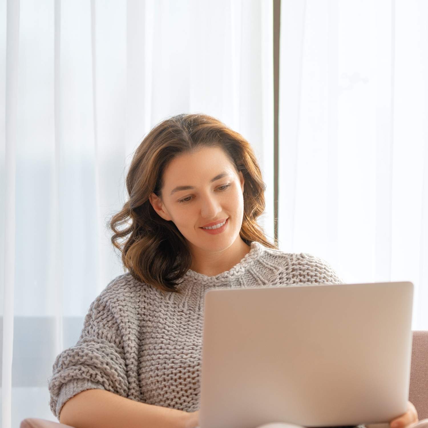 gre-accommodations-evaluation-woman-laptop Woman using a laptop preparing for the GRE and reviewing accommodations evaluation requirements