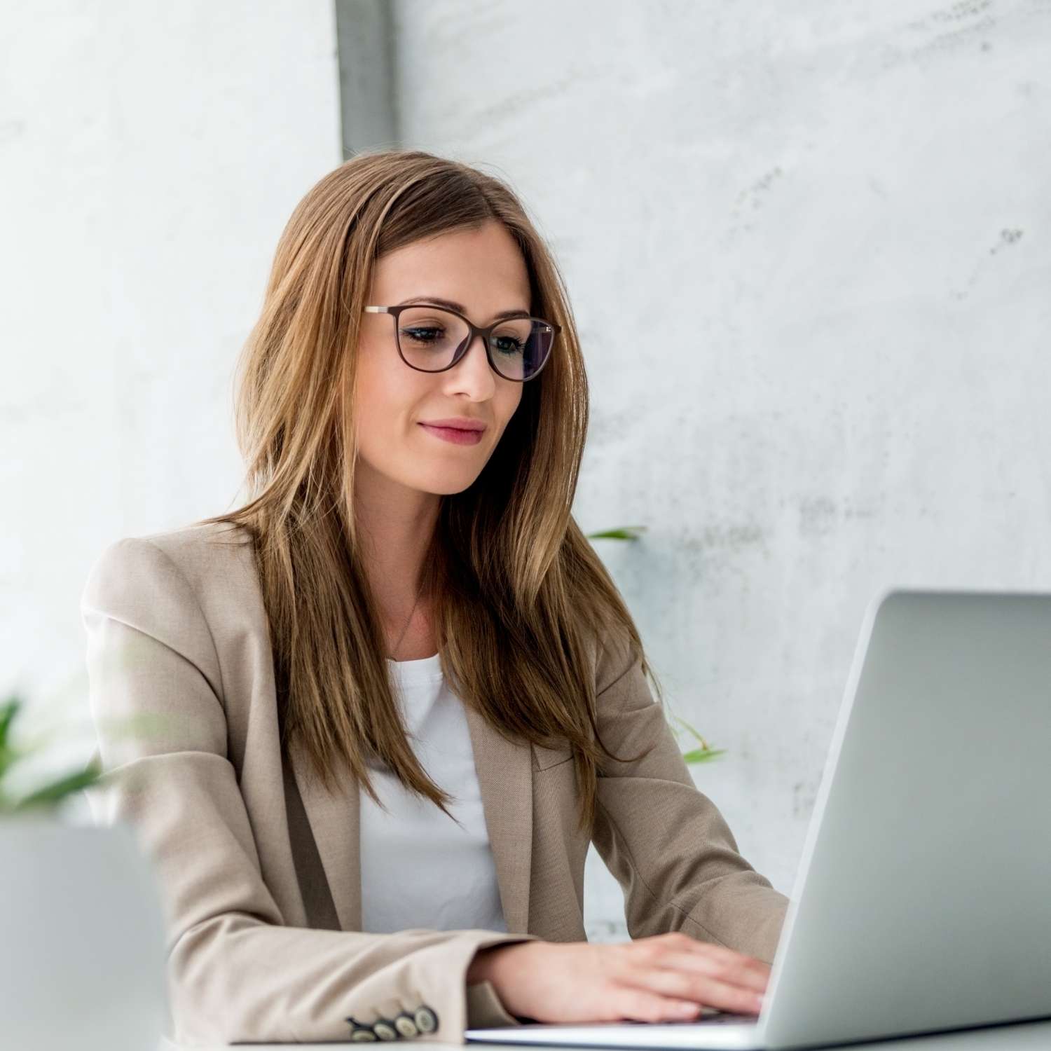 Woman typing on a laptop while preparing documentation for USMLE accommodations evaluation